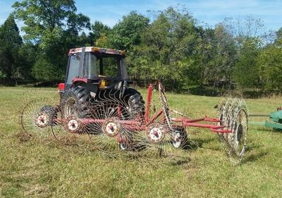 tractor with tedding equipment for hay