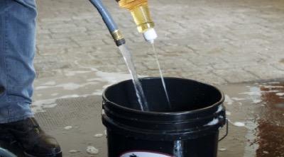 horse grooming oil in bucket with water