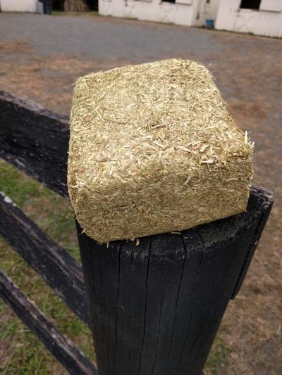 compressed hay on a fence post