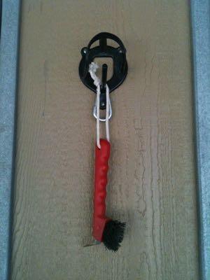 hoof pick on a halter hook outside the stall