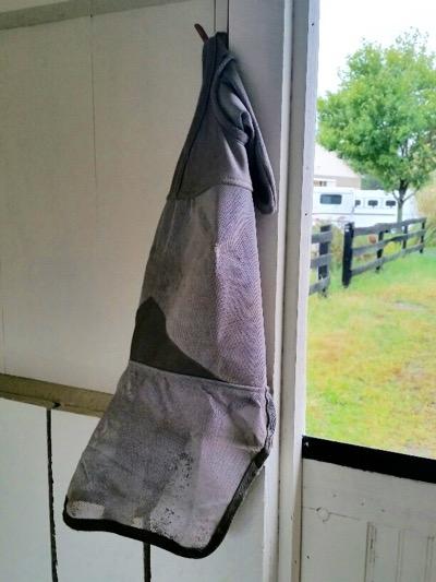 fly mask hanging on a hook