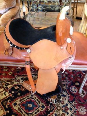 western saddle with suede seat on a bench