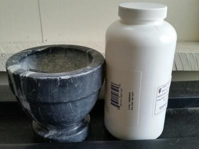 mortar and pestle with pill bottle