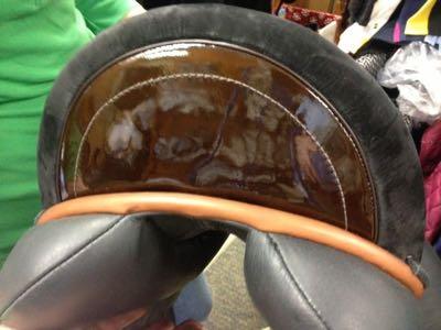 dressage saddle with patent leather accent