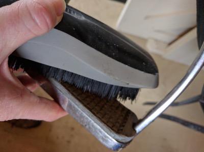 stiff brush cleaning a stirrup