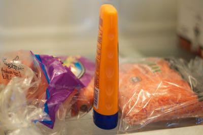 sunscreen and carrots in barn fridge