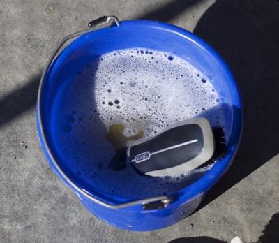 bucket with bubbles and a hard brush