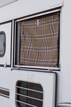 horse trailer window that hinges at the bottom with a window screen