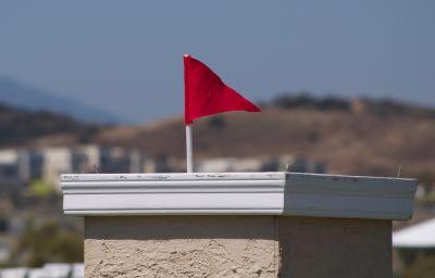 red flag on the top of a horse jump