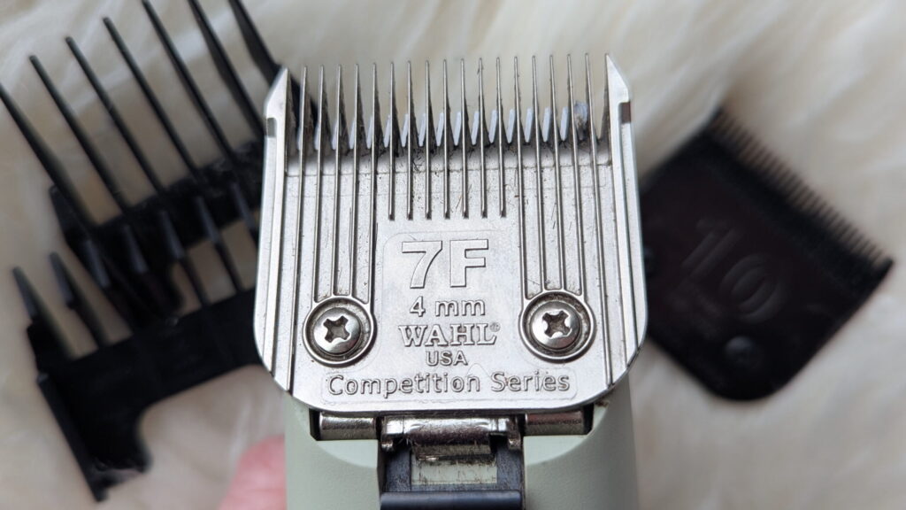 close up of a #7F blade on horse clipper body with combs in the background