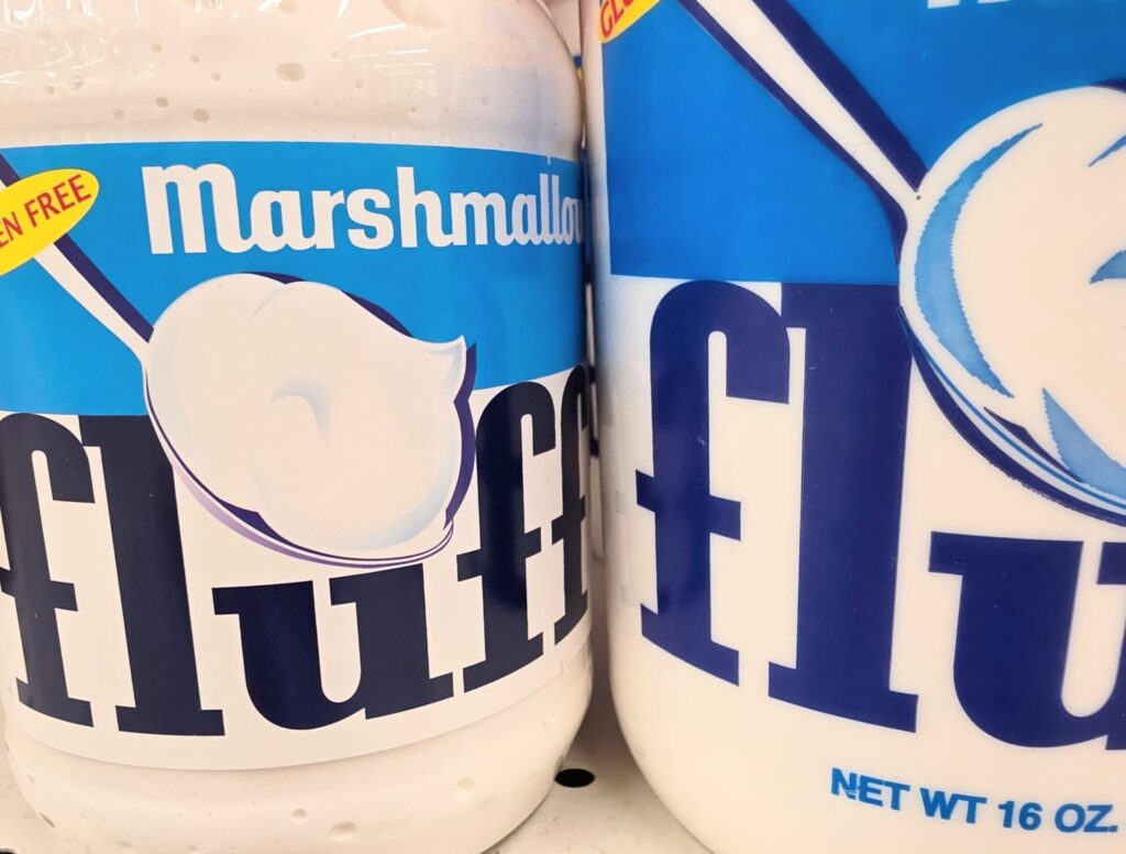 2 tubs of marshmallow fluff on a store shelf