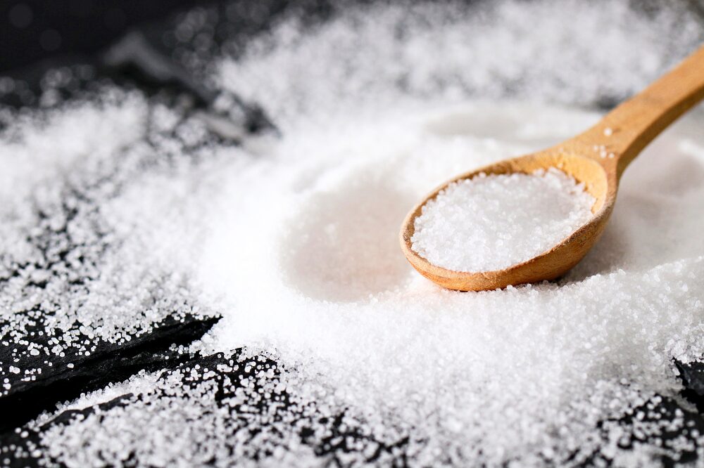 pile of salt with a wooden spoon